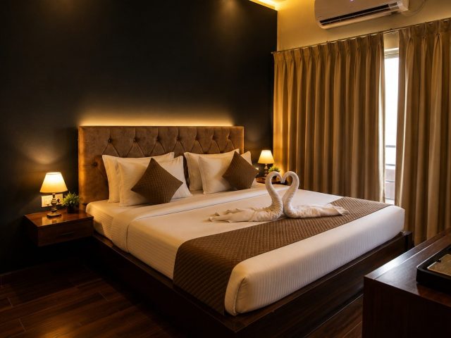 Double bed with a tufted headboard in an Executive Room with Balcony