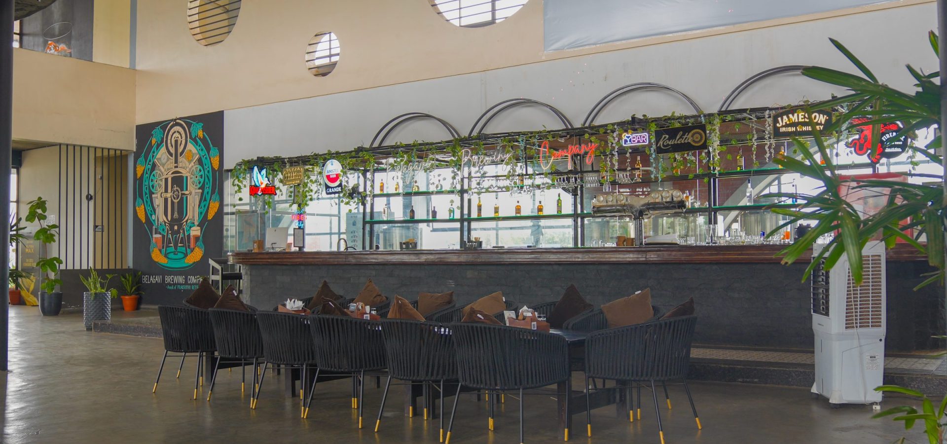 Bar counter with high tables at Belagavi Brewing Company