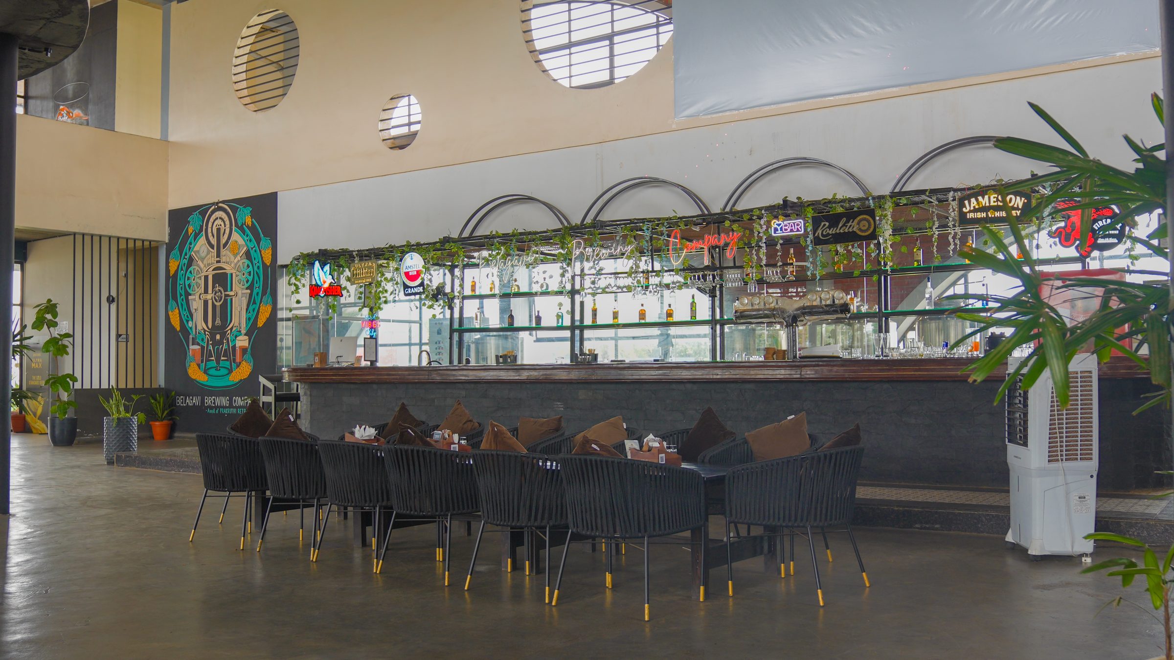 Bar counter with high tables at Belagavi Brewing Company