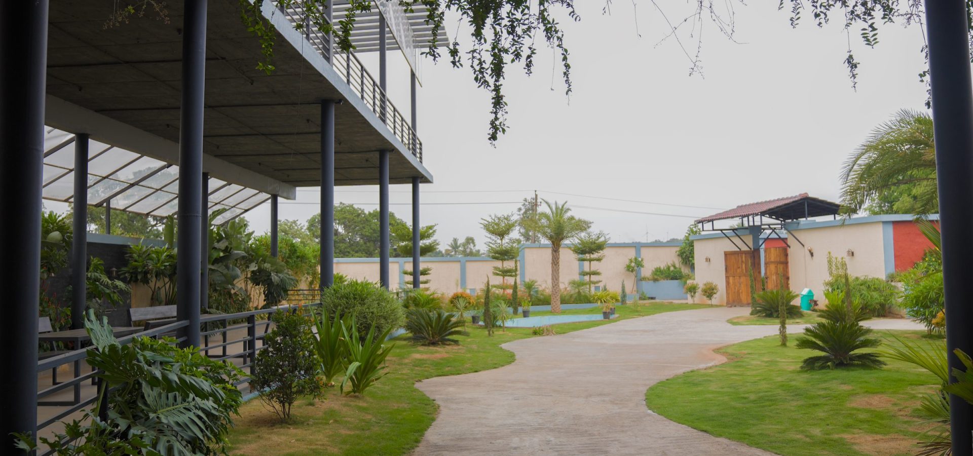 Garden path through landscaped lawns at Prakruthi Retreat