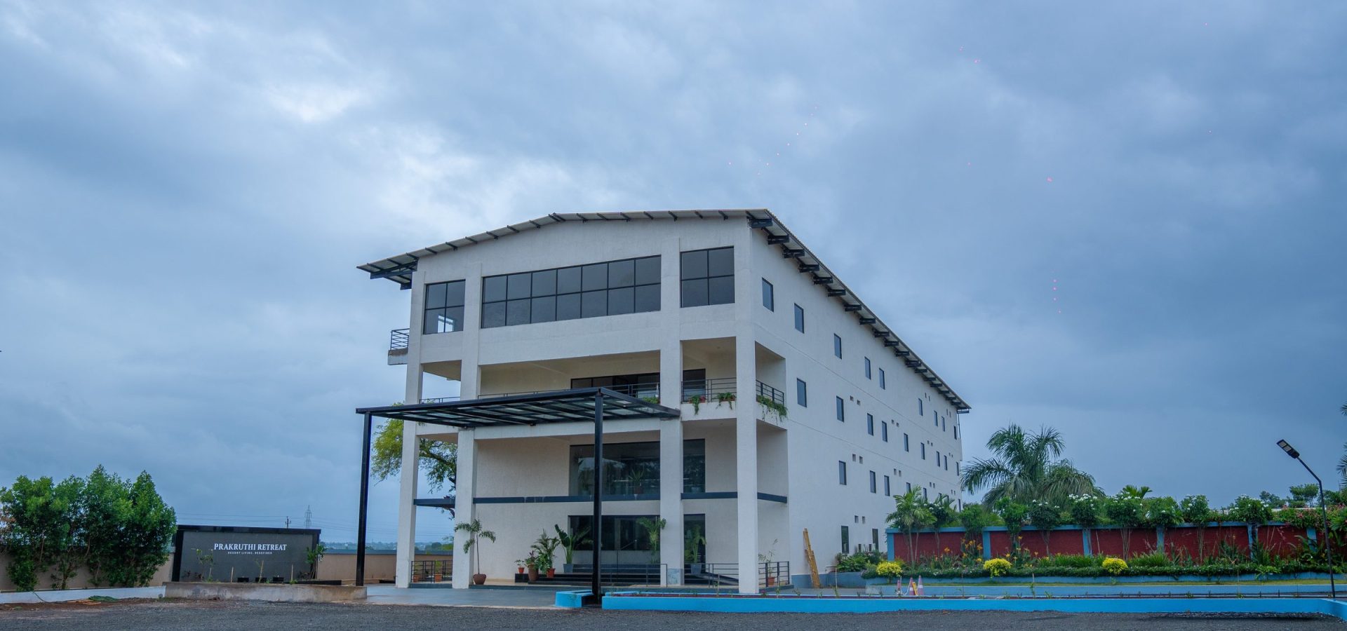 Prakruthi Retreat main building at dusk